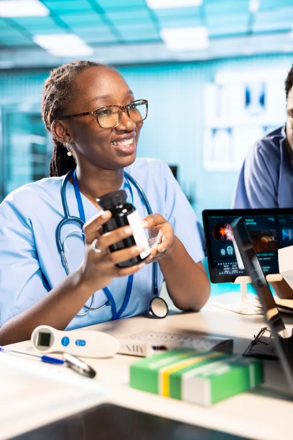 Clinician explaining a bottle of medication to a patient